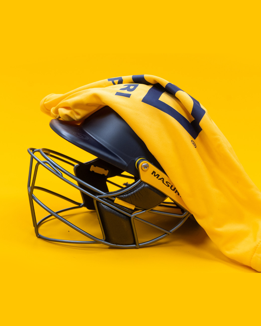 Masuri E Line Player Steel navy cricket batting helmet shown with the included premium Masuri carry bag