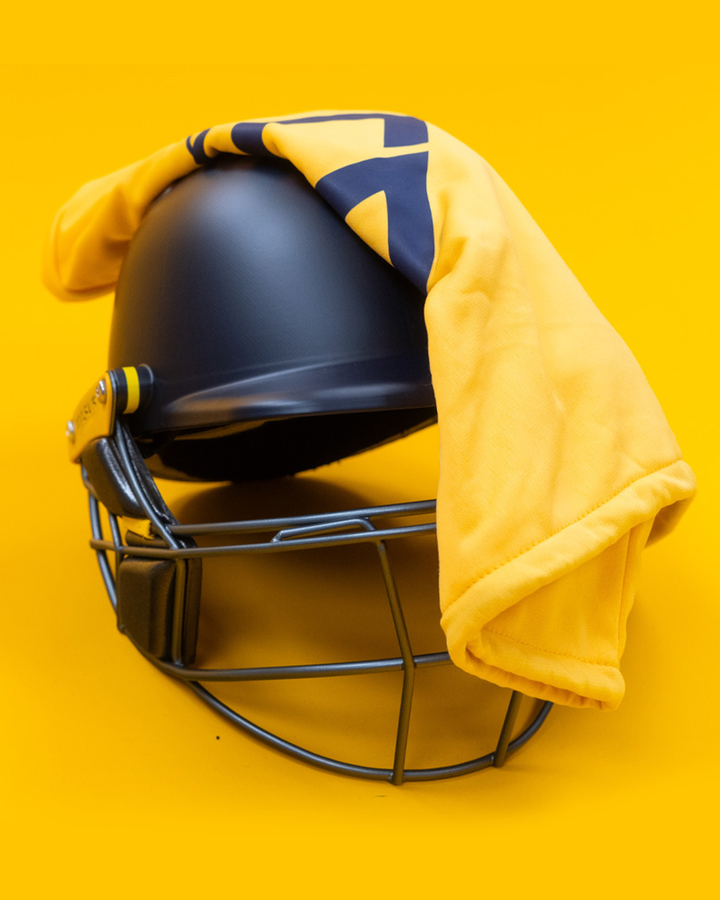 Masuri E Line Player Steel navy cricket batting helmet with the included premium Masuri helmet bag draped over the top