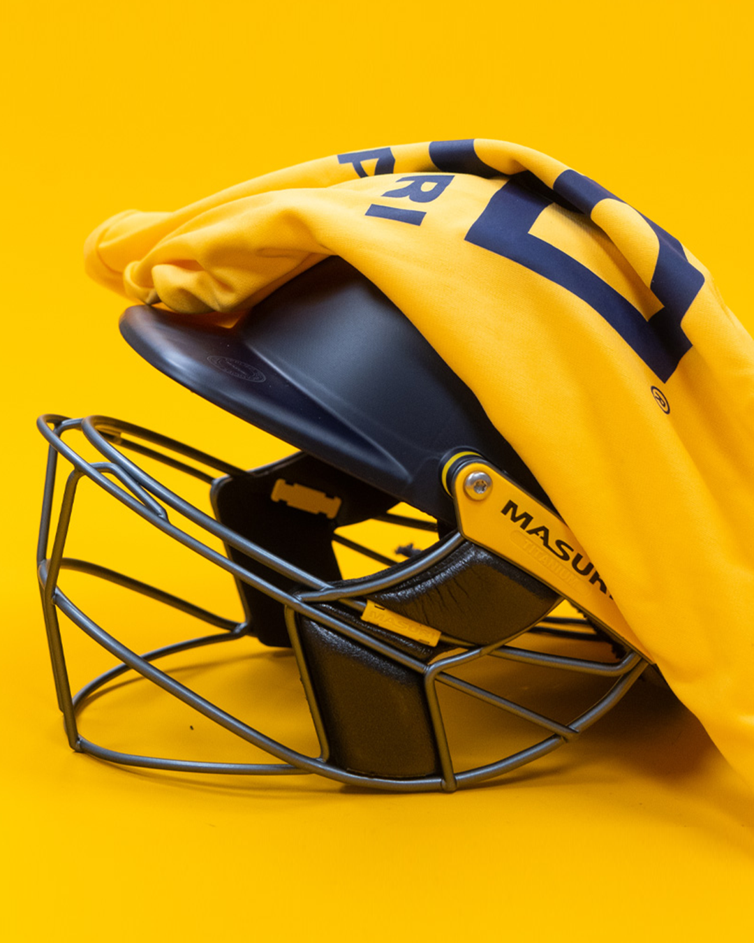 Masuri E Line Player Titanium navy cricket helmet with the included premium carry bag, fitted with StemGuard Lite 2.0 neck protection