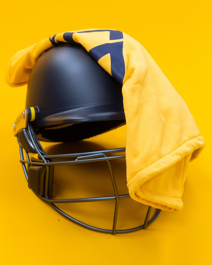 Front view of the Masuri E Line Player Titanium navy cricket helmet with titanium grille and carry bag, fitted with StemGuard Lite 2.0 neck protection